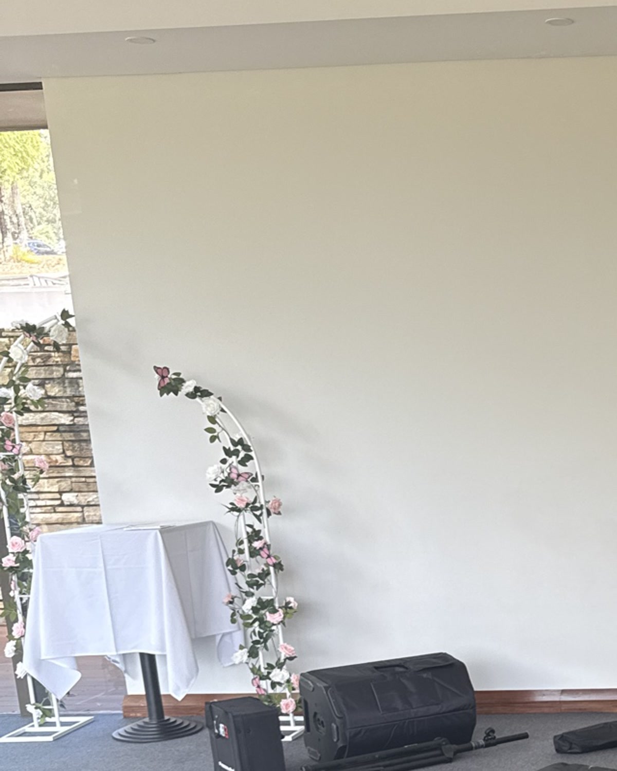 Ceremony setup at Araluen Estate — floral arch, signing table and stone alcove ready for guest arrival.